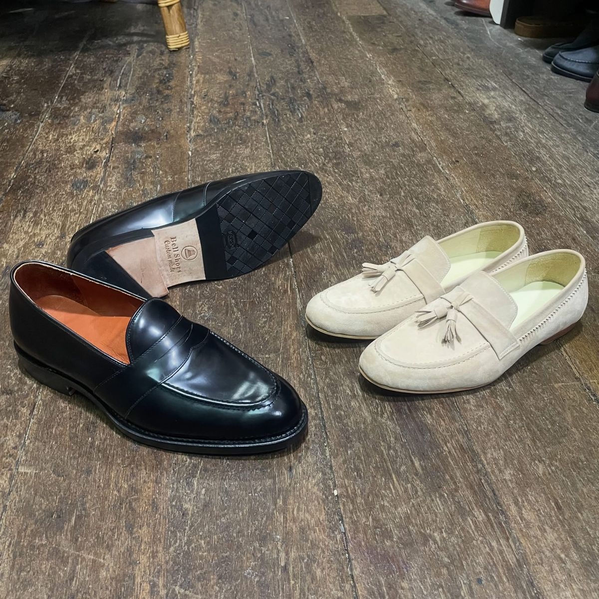 Black penny loafer and cream suede tassel loafer